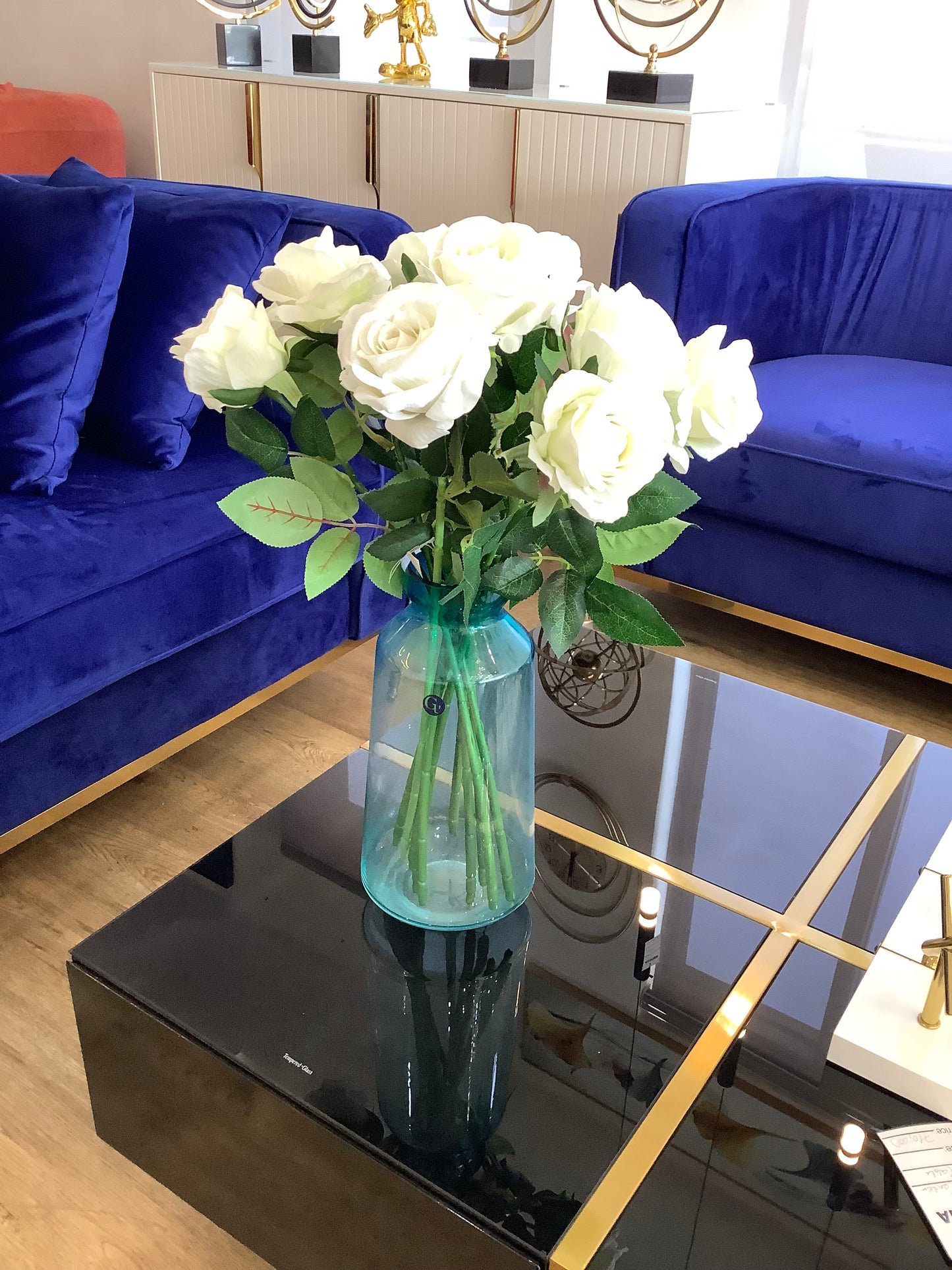 Glass vase and white roses