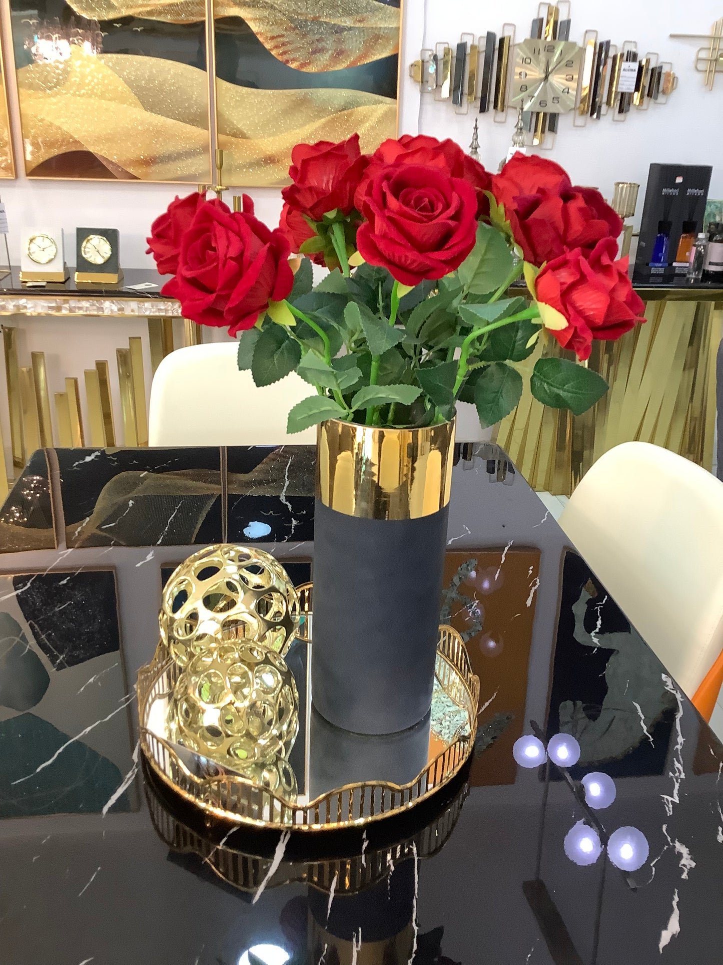 Black and gold vase with rose