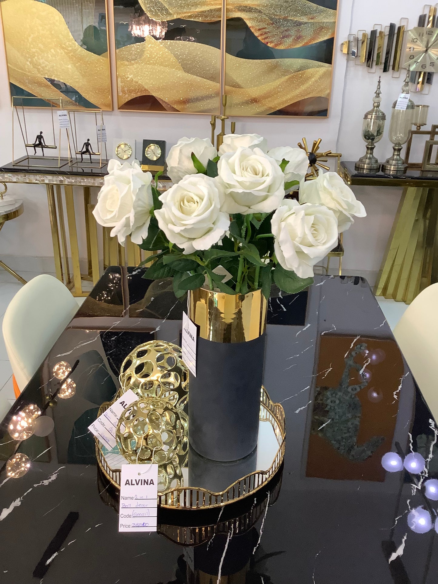 Black and gold vase with rose