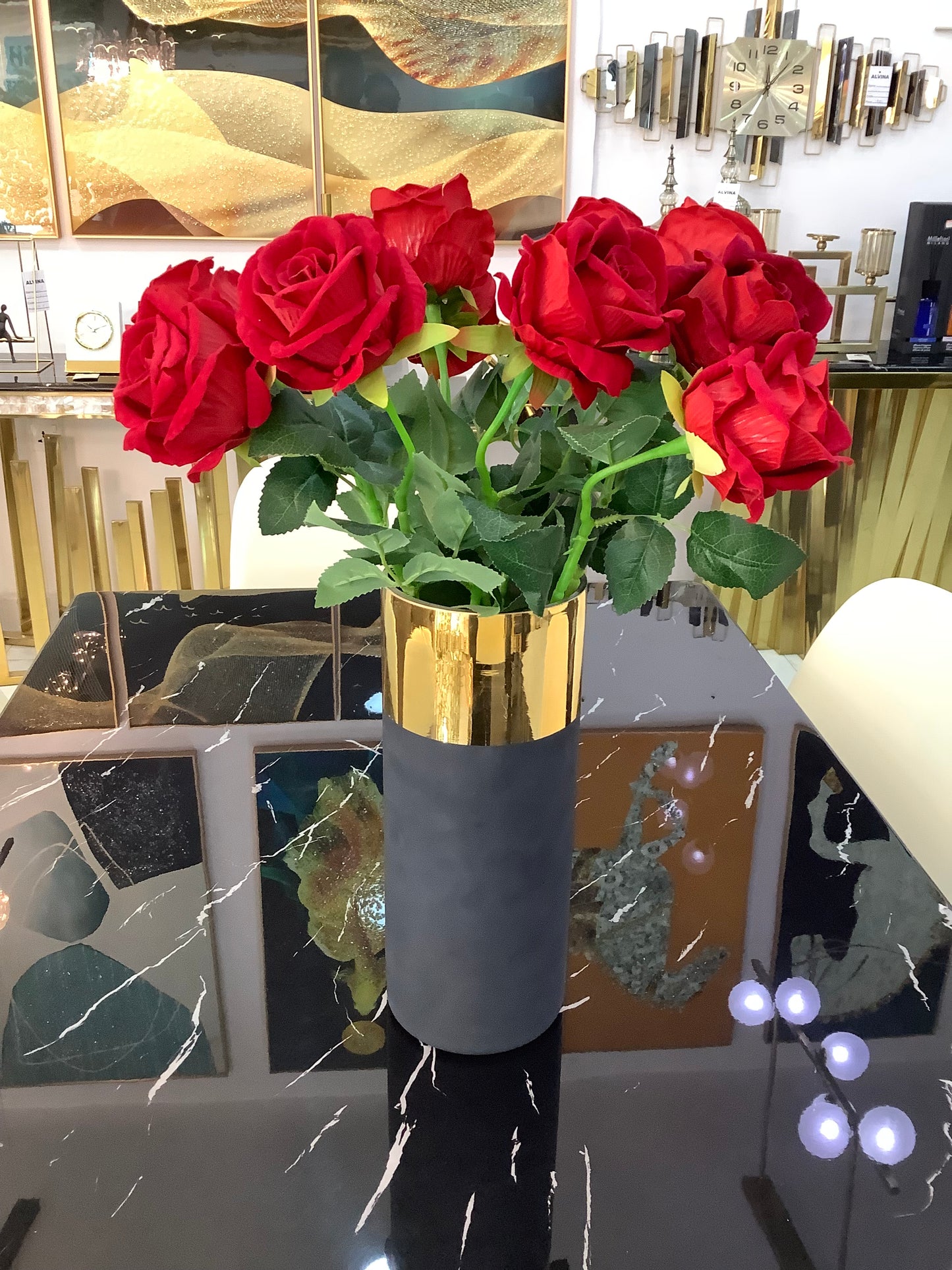 Black and gold vase with rose